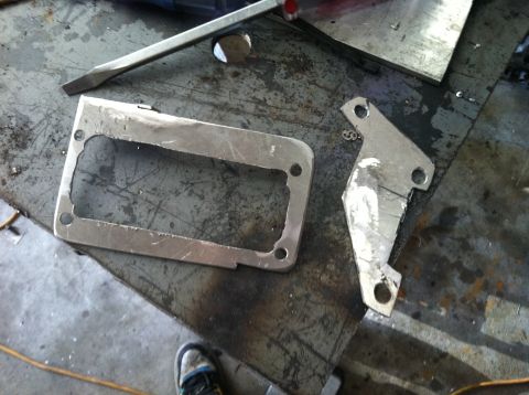 1993 Ford Probe - Metal parts and tools are laid out on a workbench, suggesting a repair or fabrication project.