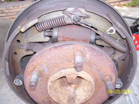 1990 Ford Bronco - Drum brake assembly with visible springs and brake shoes, dated 09/20/2012.