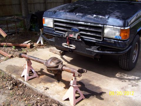 1990 Ford Bronco - Front view of a 1990 Ford Bronco with its rear axle removed and placed on jack stands.