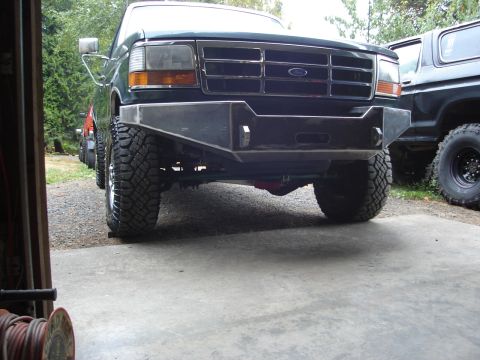 1989 Ford Bronco - Custom bumper on a 1992 Ford F-Series truck, parked next to another vehicle.