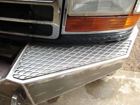 1989 Ford Bronco - Close-up of a custom metal bumper with diamond plate on a 1992 Ford truck.