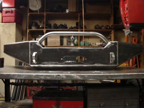 1989 Ford Bronco - A fabricated steel bumper, likely for an off-road vehicle, is shown in a workshop setting.