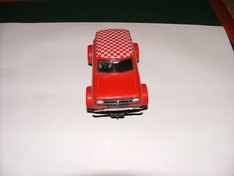 1980 MINI Cooper - A red toy car with a red and white checkered roof is displayed on a white surface.
