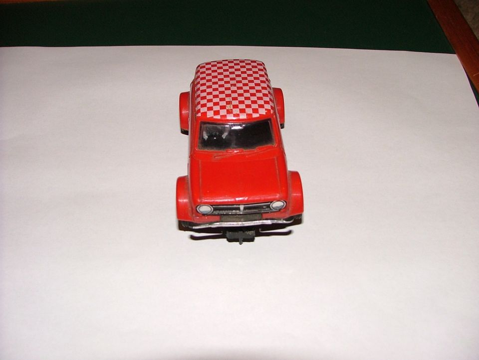 Red toy car with a checkered roof, viewed from the front