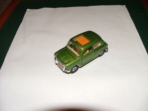 1980 MINI Cooper - A green toy car sits on a white surface, its sunroof clearly visible.