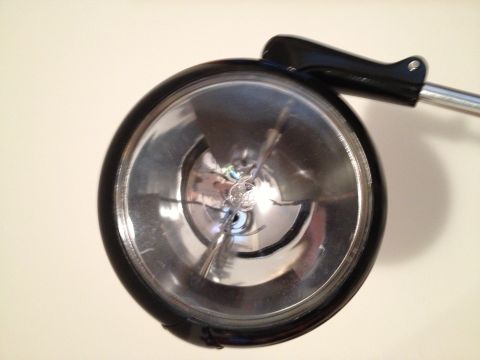 1979 Ford F-350 - Headlight assembly with a visible bulb filament and chrome reflector.