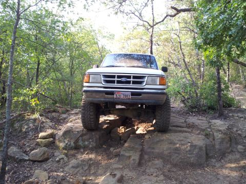 1994 Ford Ranger - A white 1994 Ford Ranger navigates a rocky trail, its off-road capabilities.