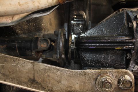 1991 Mazda Miata - Underside view of a vehicle's driveshaft and differential assembly, with visible bolts and a U-joint.