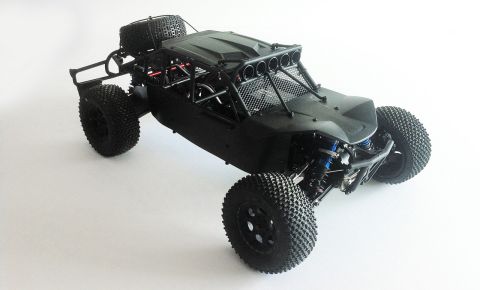 1986 Ford Bronco - This off-road buggy features a spare tire mounted on the rear and a light bar on the roof.
