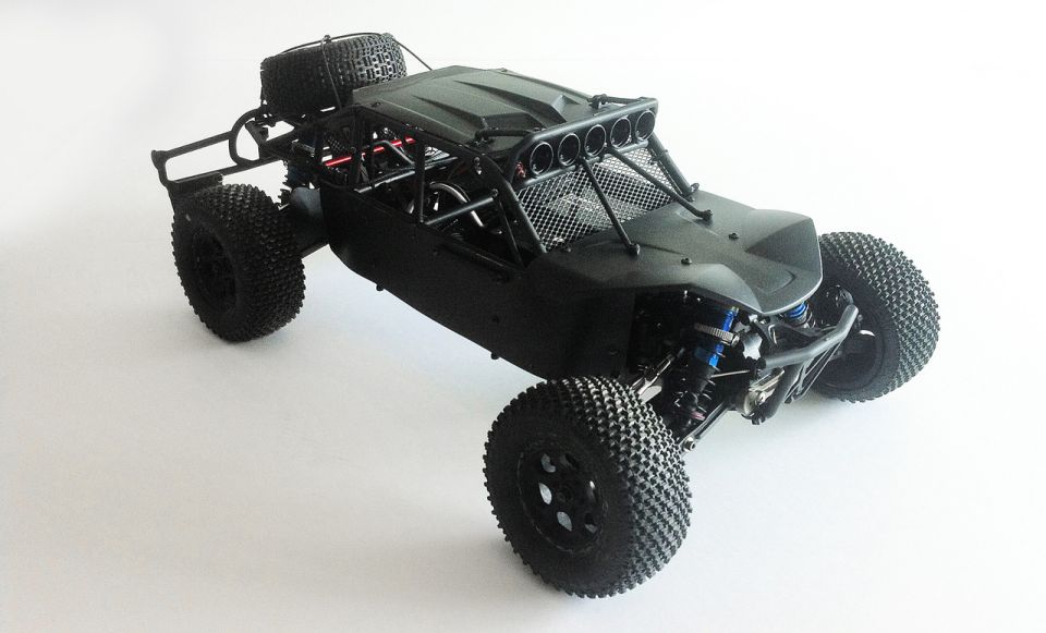 Black off-road buggy with large tires and a roll cage