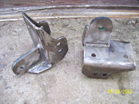 1990 Ford Bronco - Two custom metal brackets are shown, likely for a vehicle modification project.
