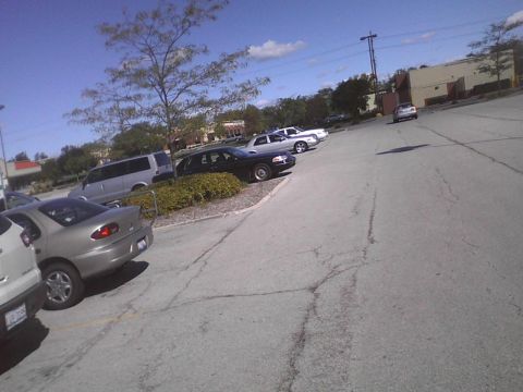 2003 Ford Crown Victoria - A black 2003 Ford Crown Victoria is seen from the side in a parking lot.
