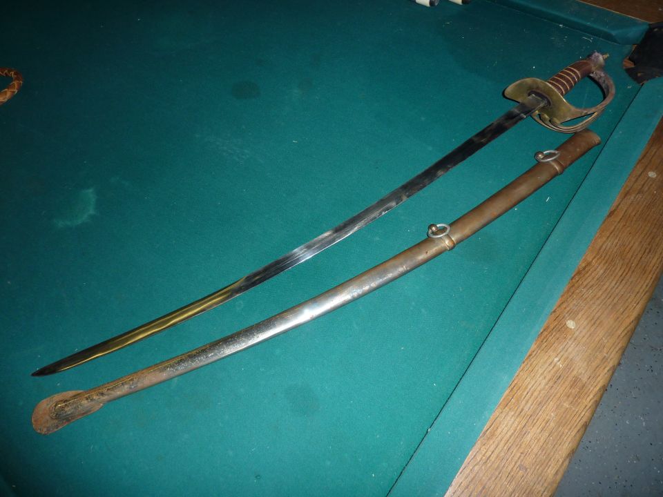 Sword and scabbard on a pool table