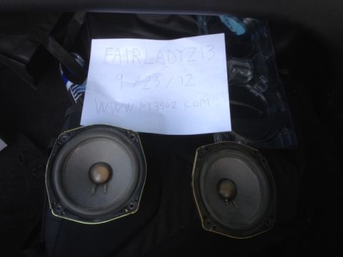 1996 Ford Bronco - A note with writing and two car speakers are shown, possibly in a vehicle's trunk.