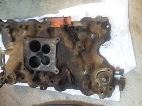 1979 Ford F-150 - This is a close-up view of a used engine intake manifold, showing signs of wear and tear.