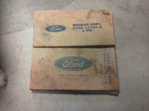 1979 Ford F-150 - Two vintage Ford mirror assembly boxes are stacked, with part numbers and company information visible on the packaging.