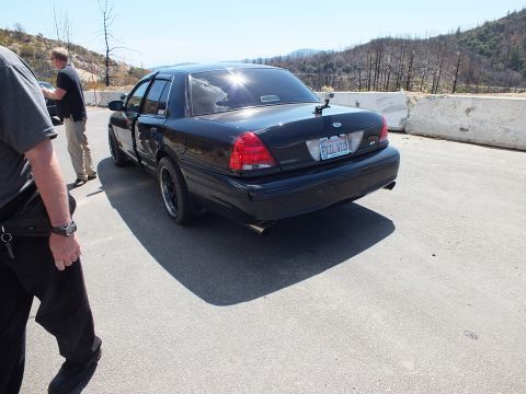 2003 Ford Crown Victoria - Blacked-out Crown Victoria from the rear showing dual exhaust and EVIL VIC plate.