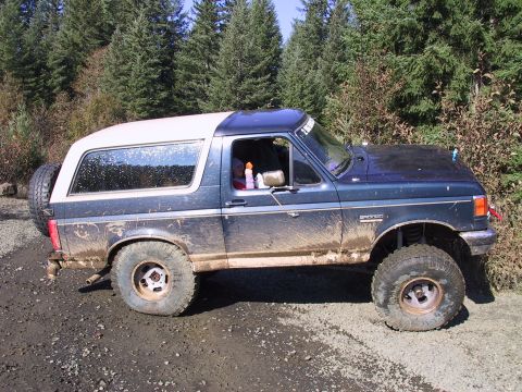 1991 Ford Bronco - Muddy 1991 Ford Bronco on a dirt road, likely after off-roading.