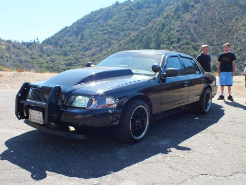2003 Ford Crown Victoria - Front three-quarter of a modified black Crown Victoria, lowered on multi-spoke wheels