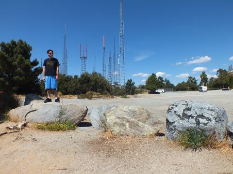 2003 Ford Crown Victoria - Person stands among large rocks at a summit lined with broadcast masts