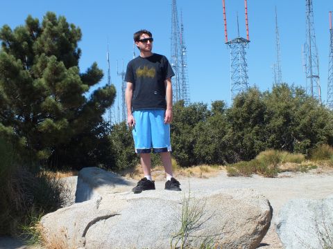 2003 Ford Crown Victoria - Sunglasses-wearing person poses on stone with transmission towers behind