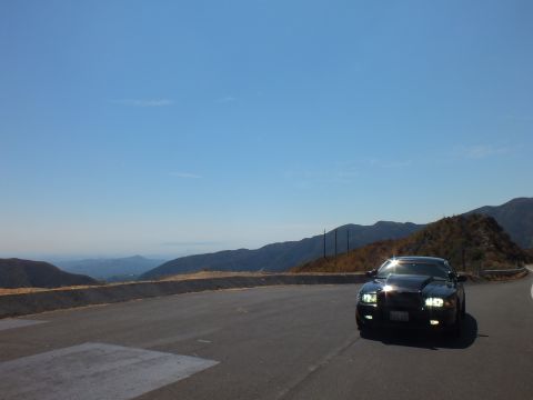 2003 Ford Crown Victoria - Distant black Mercury sedan at a mountain turnout with sweeping valley view.