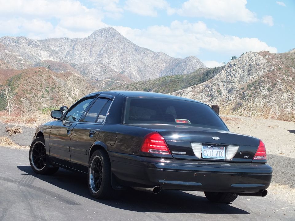 Black Mercury Grand Marquis rear-quarter with Mercury emblem and EVIL VIC plate