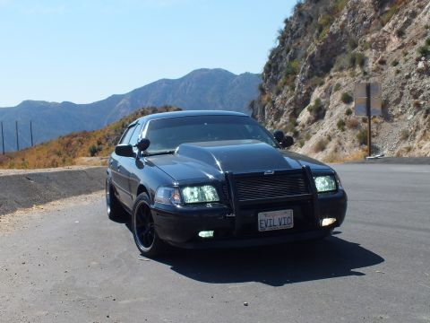 2003 Ford Crown Victoria - Crown Vic front-corner shot at a canyon turnout with curving road in the distance.