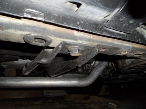 1973 Ford Ranchero - Close-up view of the undercarriage, showing the exhaust system and structural components of a vehicle.