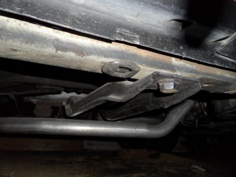 1973 Ford Ranchero - The underside of a vehicle shows the frame, suspension components, and exhaust pipe.