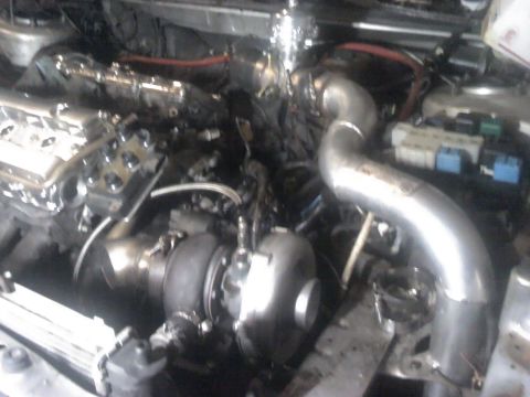 1995 Ford Probe - The engine bay shows a turbocharger and custom piping, not a 1995 Ford Probe.