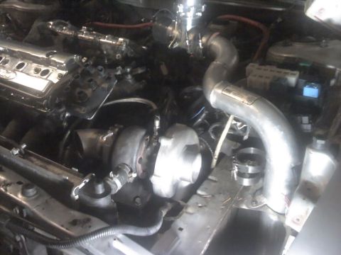1995 Ford Probe - Engine bay with twin turbochargers and custom piping, indicating performance modifications.