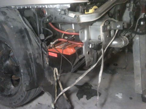 1995 Ford Probe - Close-up of a car battery and its associated wiring in the engine compartment.