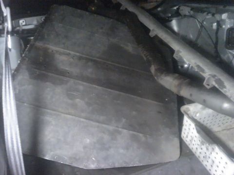 1995 Ford Probe - The interior cargo area shows a large plastic panel and part of an exhaust system.