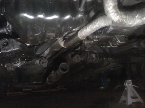1995 Ford Probe - The underside of a vehicle is visible, focusing on the exhaust system and heat shielding.