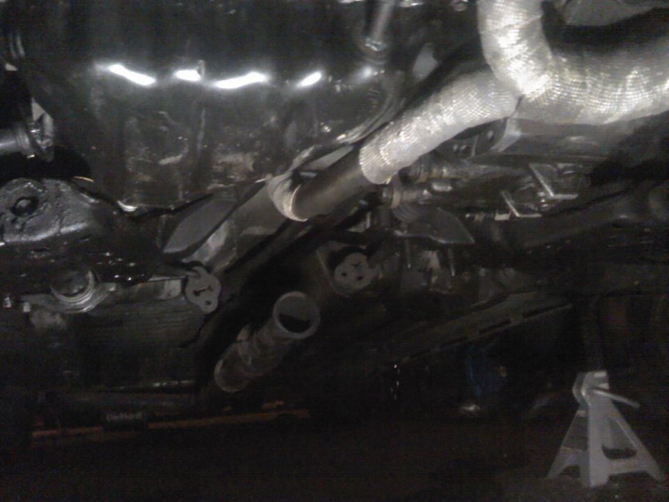 underneath car showing exhaust pipes and heat shielding