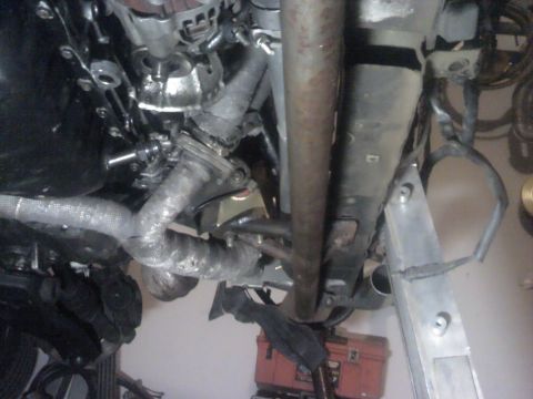 1995 Ford Probe - Underside view of a 1995 Ford Probe engine compartment, showing exhaust manifold and piping.
