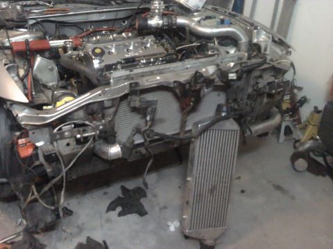 1995 Ford Probe - The engine bay is partially disassembled, revealing the intercooler and various engine parts.