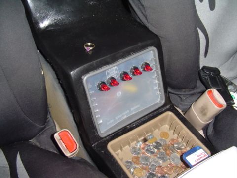 1999 Ford Taurus - A custom center console modification features toggle switches and a coin holder filled with assorted currency.