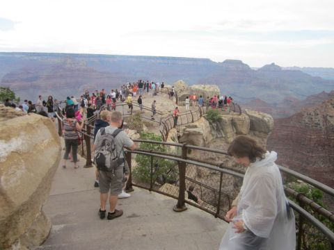 1991 Ford LTD Crown Victoria - People gather at a viewpoint to admire the vast landscape of the Grand Canyon.