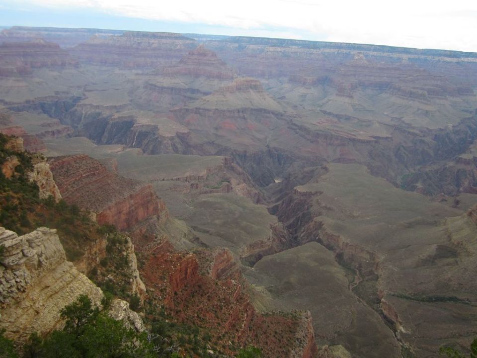 Grand Canyon landscape with layered rock formations and a distant river