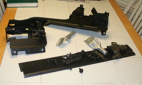 1976 Ford Ranchero - Several disassembled vehicle components are laid out on a table, likely for repair or restoration.