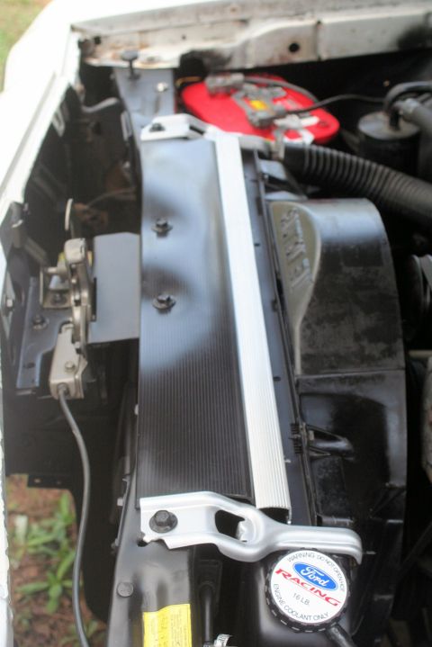 1976 Ford Ranchero - Close-up view of the engine bay of a 1976 Ford Ranchero, highlighting the radiator and associated components.