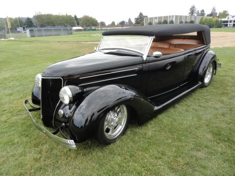 1964 Ford Fairlane - This black 1935 Ford convertible hot rod features a tan interior and chrome wheels.