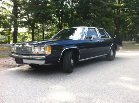 1991 Ford LTD Crown Victoria - A 1991 Ford Crown Victoria LTD is shown from the front three-quarter view, parked outdoors.