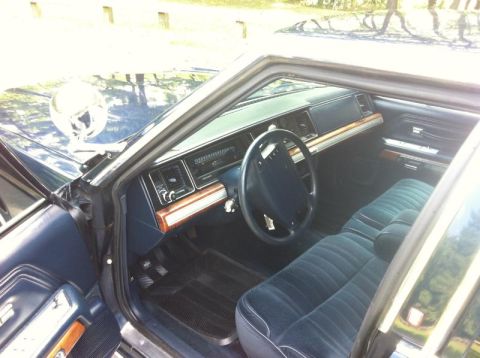 1991 Ford LTD Crown Victoria - Interior view of a 1991 Ford Crown Victoria LTD, showing the dashboard, steering wheel, and front seats.
