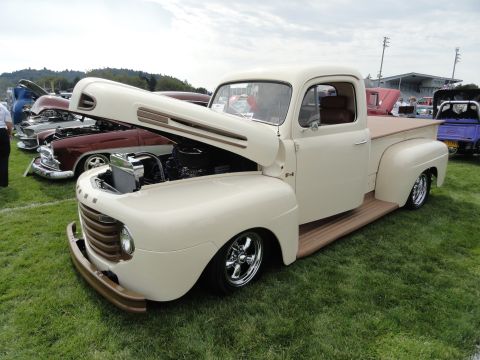 1964 Ford Fairlane - Cream pickup truck with open hood at a car show, with other vehicles visible.