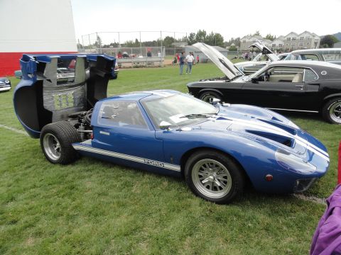 1964 Ford Fairlane - A blue 1966 Ford GT40 is displayed with its engine cover open at a car show.