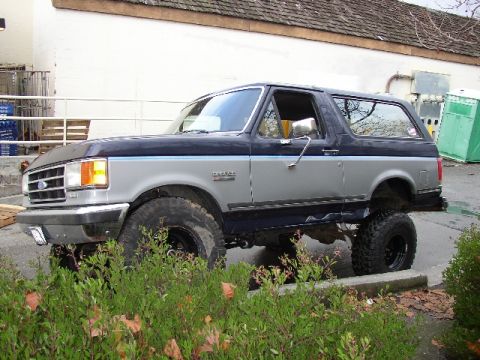 1989 Ford Bronco - This lifted 1989 Ford Bronco has large off-road tires and a two-tone paint scheme.