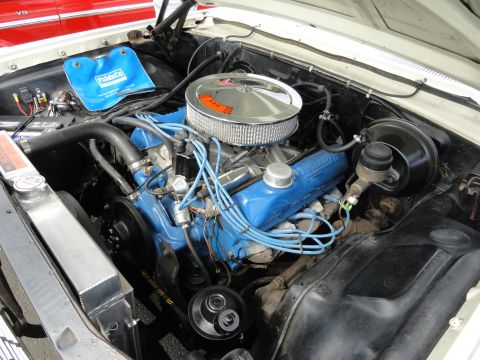 1964 Ford Fairlane - The engine bay features a blue Ford engine with a chrome air cleaner and a blue "FordCo" bag.